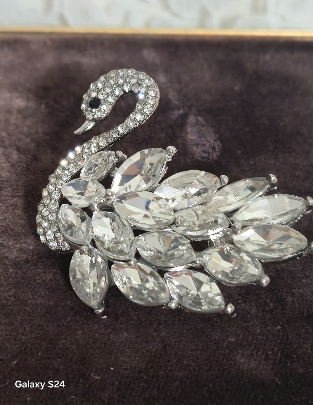 silver-toned swan brooch accented with pavé rhinestones
